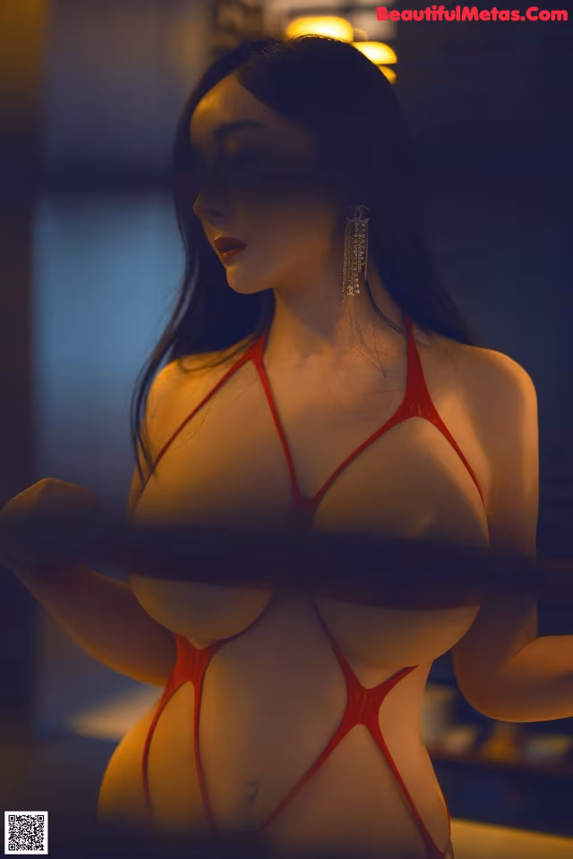 A woman in a red lingerie holding a knife.
