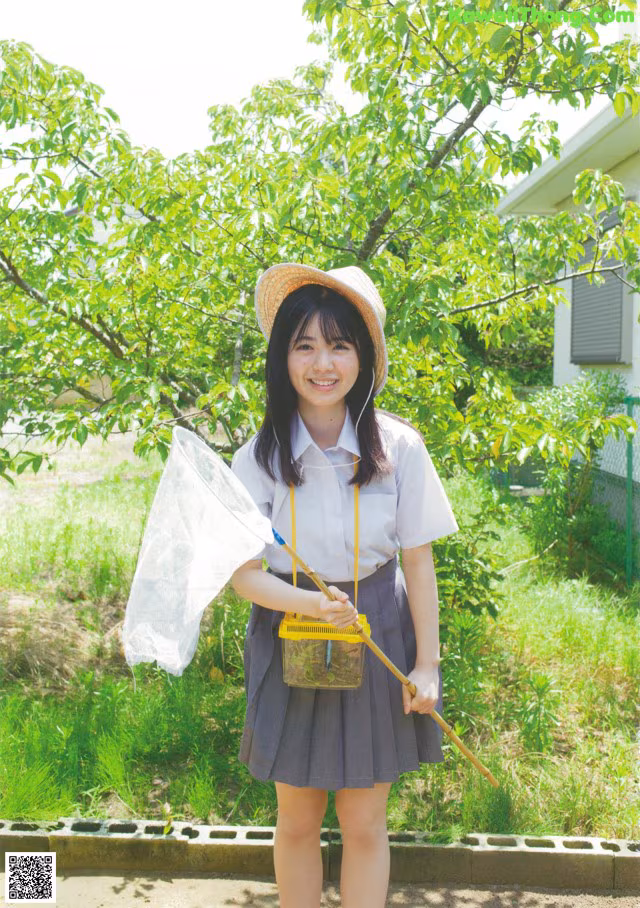 A young woman in a school uniform holding a net.