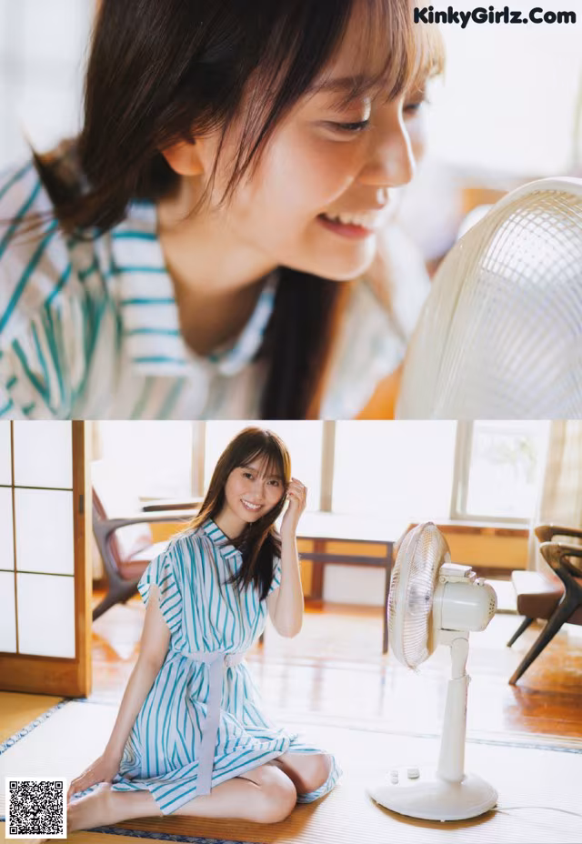 A woman sitting on the floor next to a fan.