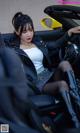 A woman sitting in the driver's seat of a car.