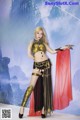 A woman dressed in a costume holding a sword.
